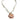 A bohemian-style necklace featuring a large scallop shell pendant with orange and brown stripes on a white background, suspended from a frayed cream fabric chain with a gold-tone clasp.
